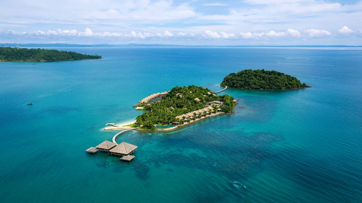 hotels in heaven Song Saa Private Island Ariel surrounded by water blue trees hill cloudy sky wide ocean