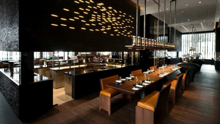 hotels in heaven chedi andermatt CAM Dining The Restaurant Commune Table kitchen wooden floor armchair leather