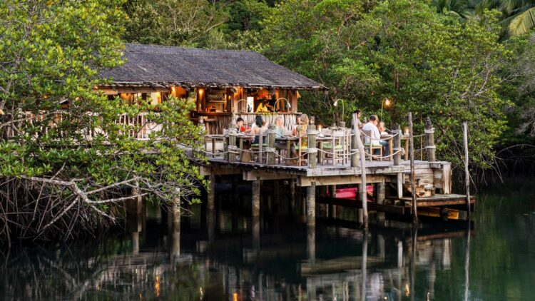 hotels in heaven soneva kiri culinary floating restaurant nature outside outdoors roof lights food water trees
