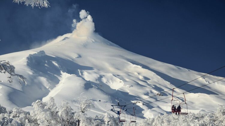 50 Skiing on Villarrica Volcano snow ski lift white blue sky tree people