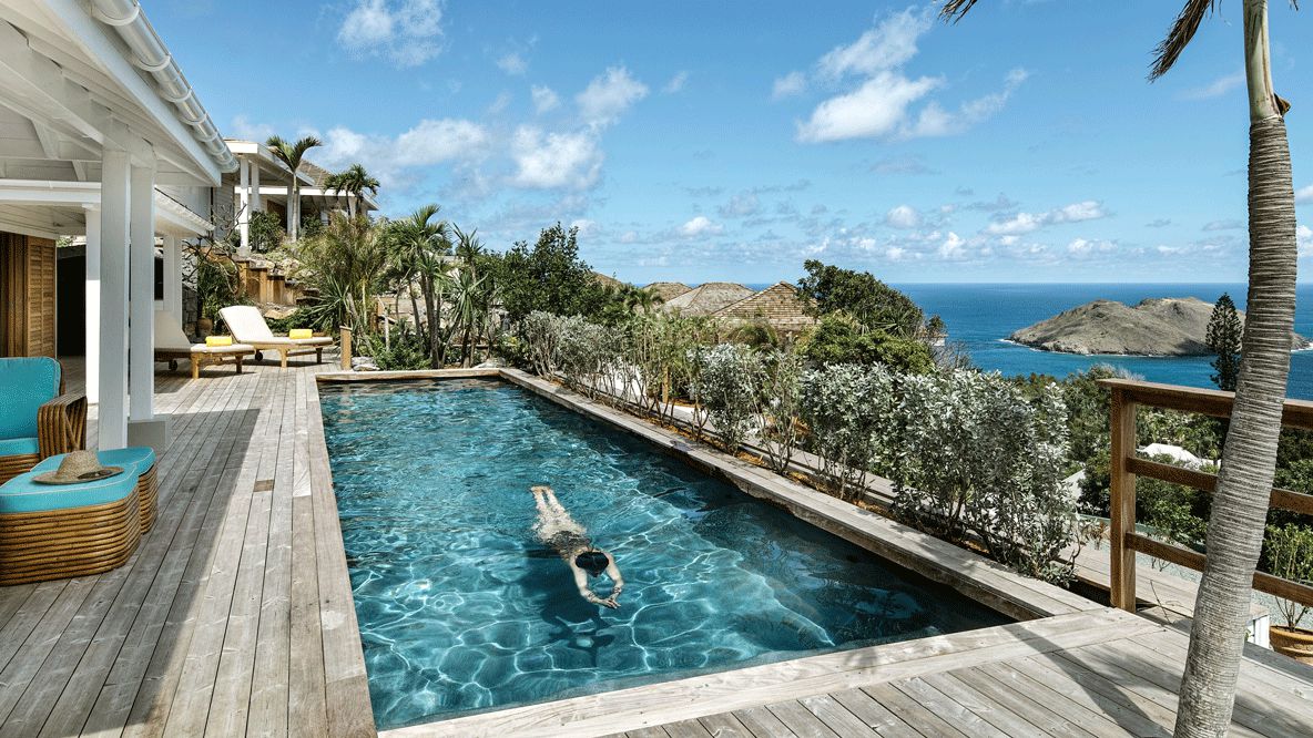 hotels in heaven villa marie saint barth outdoor pool ocean view swimming deckchair sun plants tree sea sky clouds