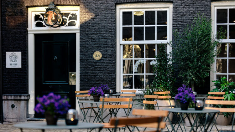 hotels in heaven the dylan amsterdam front courtyard accommodation culinary big windows flowers door outside lovely chairs plants